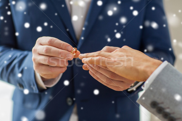 close up of male gay couple hands and wedding ring Stock photo © dolgachov