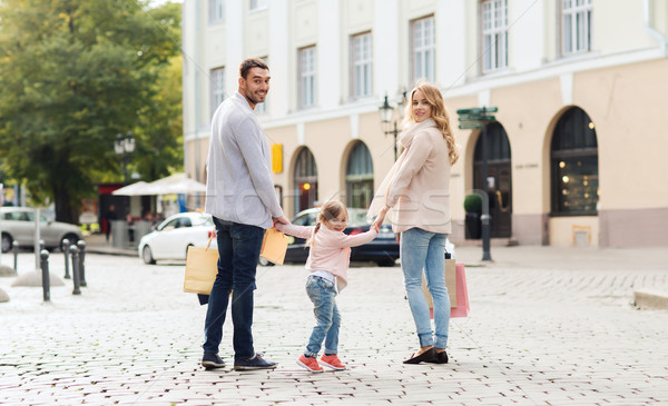 happy family with child and shopping bags in city Stock photo © dolgachov