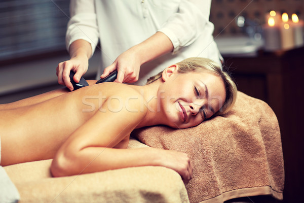 close up of woman having hot stone massage in spa Stock photo © dolgachov