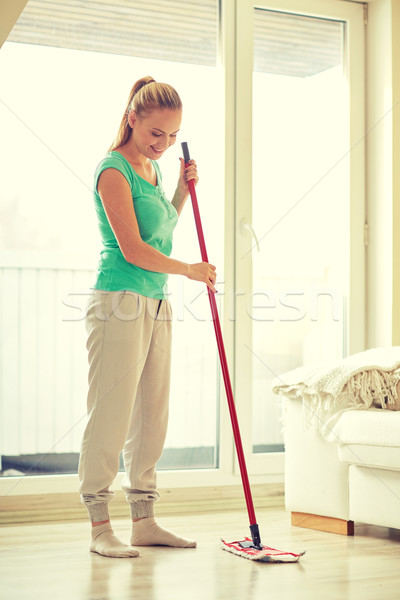 happy woman with mop cleaning floor at home Stock photo © dolgachov