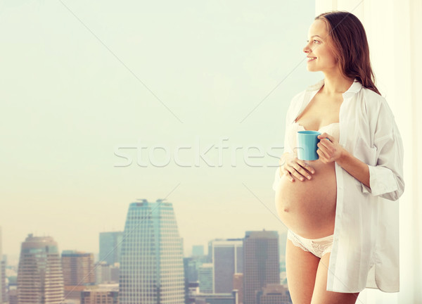 happy pregnant woman with cup drinking tea at home Stock photo © dolgachov