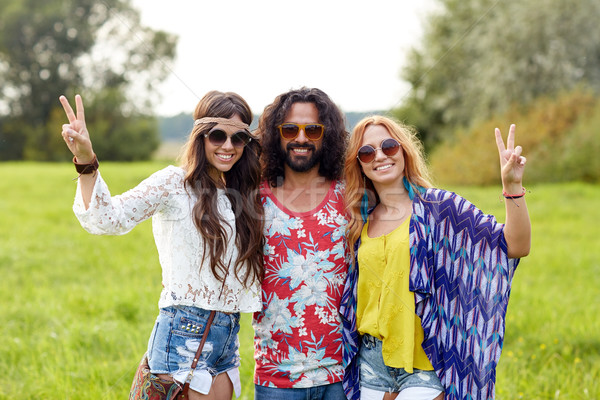 happy young hippie friends showing peace outdoors Stock photo © dolgachov