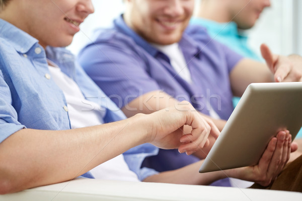 Stock photo: close up of happy friends with tablet pc at home