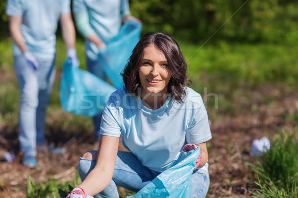 Stock photo: volunteers with garbage bags cleaning park area