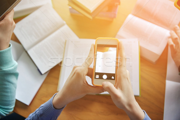 students with smartphones making cheat sheets Stock photo © dolgachov