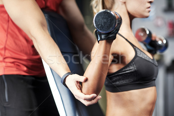 Stock photo: man and woman with dumbbells in gym