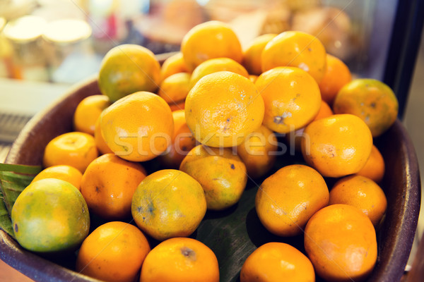 basket of fresh ripe juicy oranges at kitchen Stock photo © dolgachov
