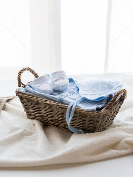close up of baby clothes for newborn boy in basket Stock photo © dolgachov
