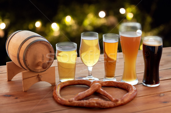 close up of beer glasses, barrel and pretzel Stock photo © dolgachov