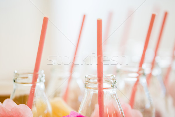 close up of glass bottles for drinks with straws Stock photo © dolgachov