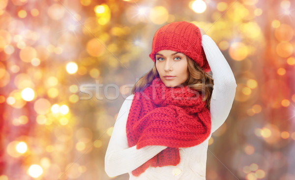 happy woman in hat, scarf and pullover over lights Stock photo © dolgachov