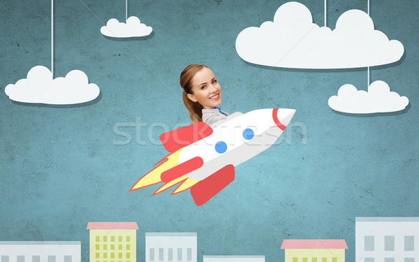 businesswoman flying on rocket above cartoon city Stock photo © dolgachov
