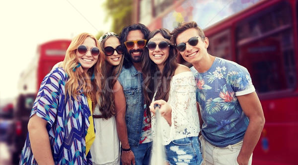 smiling hippie friends with selfie stick in london Stock photo © dolgachov