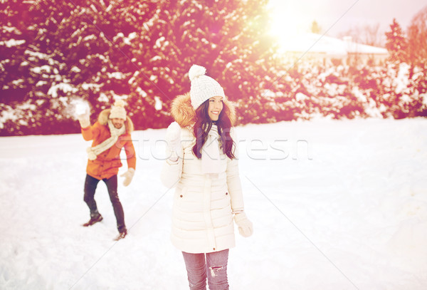 Stock photo: happy couple playing snowballs in winter