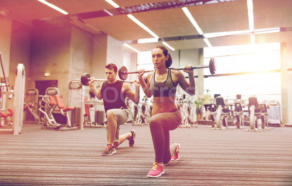 Moço mulher treinamento barbell ginásio esportes Foto stock © dolgachov