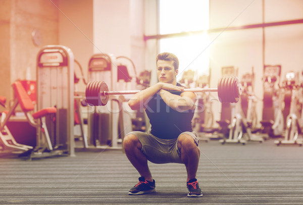Moço músculos barbell ginásio esportes Foto stock © dolgachov