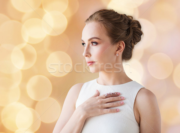 Stock photo: smiling woman in white dress with diamond jewelry