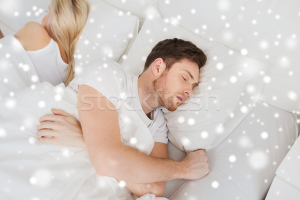 couple sleeping in bed at home Stock photo © dolgachov