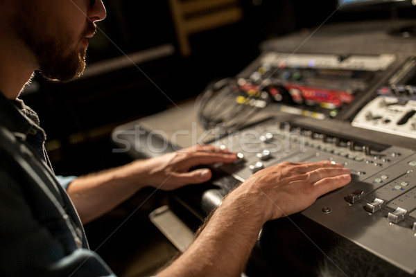 man using mixing console in music recording studio Stock photo © dolgachov
