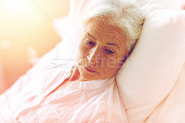 senior woman patient lying in bed at hospital ward Stock photo © dolgachov