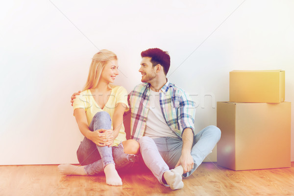 couple with cardboard boxes moving to new home Stock photo © dolgachov