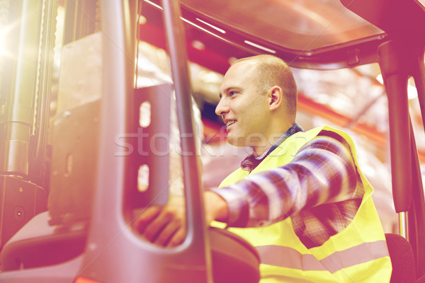 man operating forklift loader at warehouse Stock photo © dolgachov