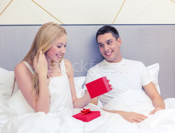 man giving woman little red gift box Stock photo © dolgachov