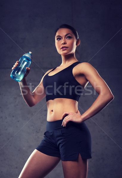 woman drinking water from bottle in gym Stock photo © dolgachov