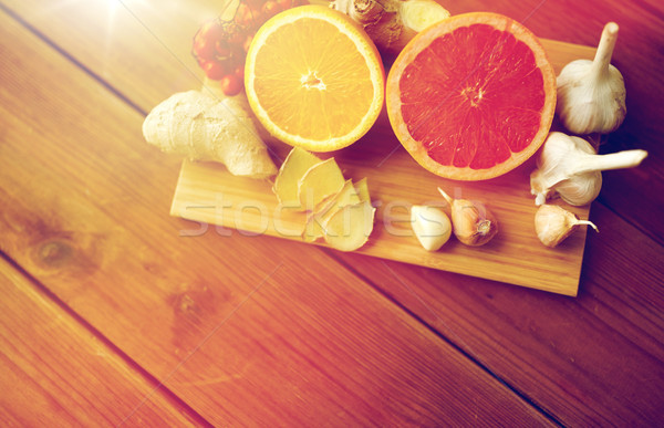 Stock photo: citrus fruits, ginger and garlic on wood