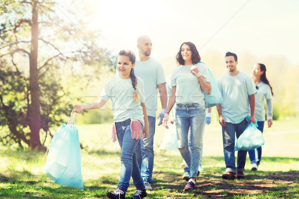 group of volunteers with garbage bags in park Stock photo © dolgachov