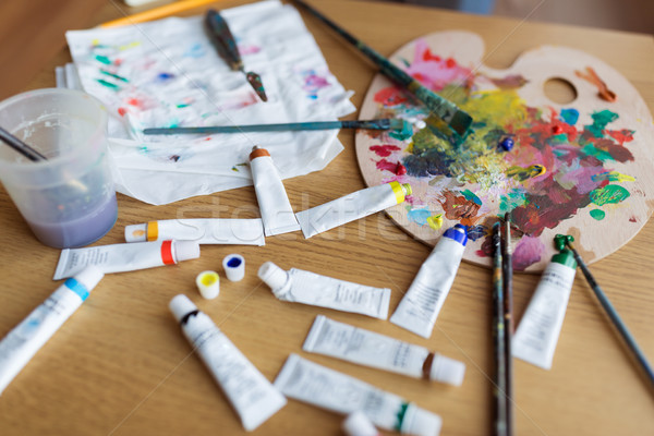 palette, brushes and paint tubes on table Stock photo © dolgachov
