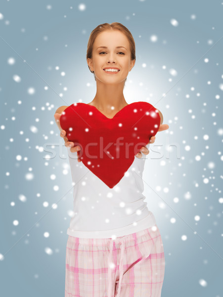 happy and smiling woman with heart-shaped pillow Stock photo © dolgachov