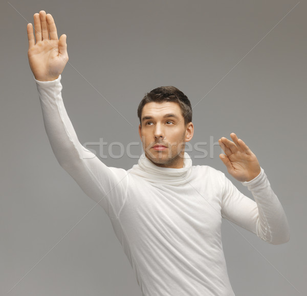 Stock photo: man working with something imaginary