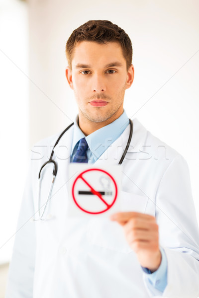 male doctor holding no smoking sign Stock photo © dolgachov
