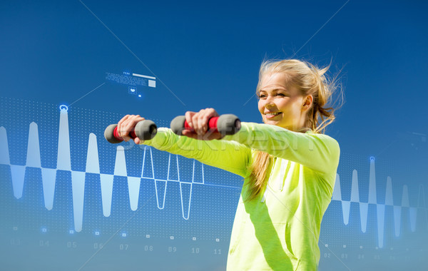 Stock photo: sporty woman with light dumbbells outdoors