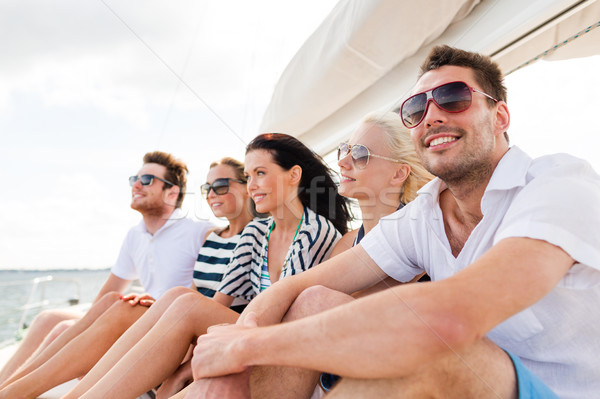 smiling friends sitting on yacht deck Stock photo © dolgachov