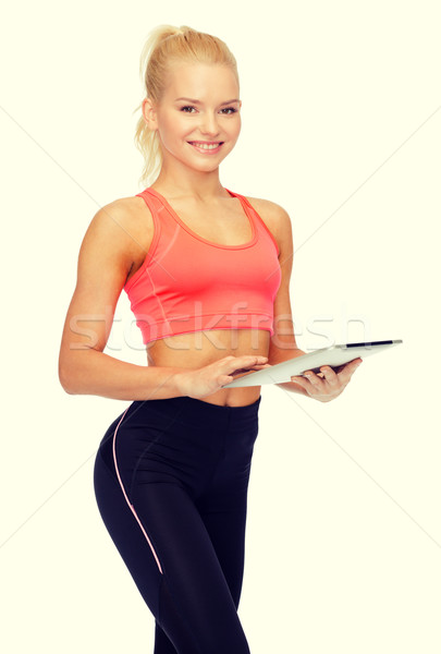smiling sporty woman with tablet pc computer Stock photo © dolgachov