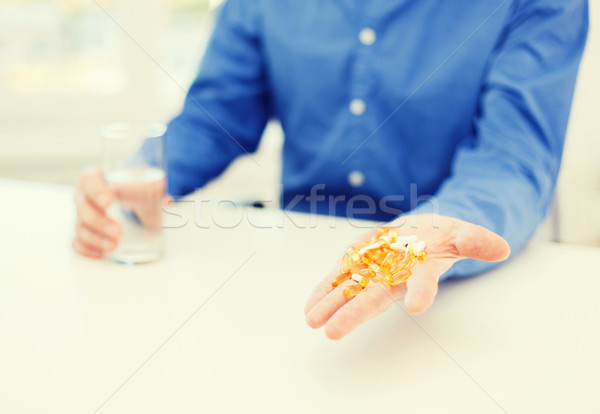 close up of male hand showing lot of pills Stock photo © dolgachov