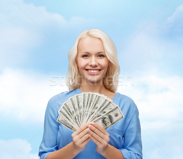 smiling young woman with us dollar money Stock photo © dolgachov