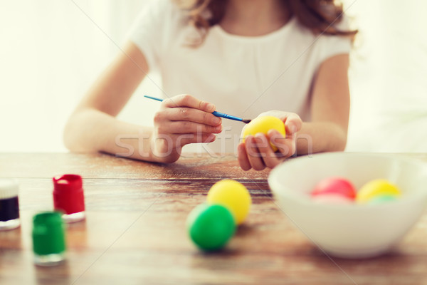 close up of girl coloring eggs for easter Stock photo © dolgachov