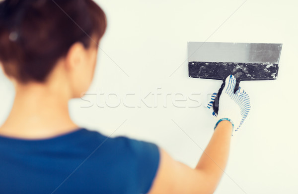 woman plastering the wall with trowel Stock photo © dolgachov