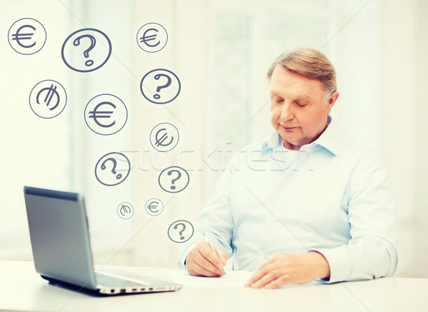 old man filling a form at home Stock photo © dolgachov