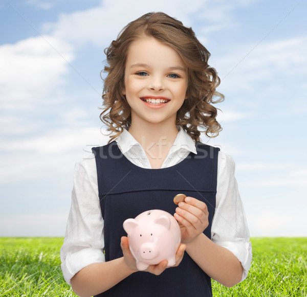 happy girl holding piggy bank and coin Stock photo © dolgachov