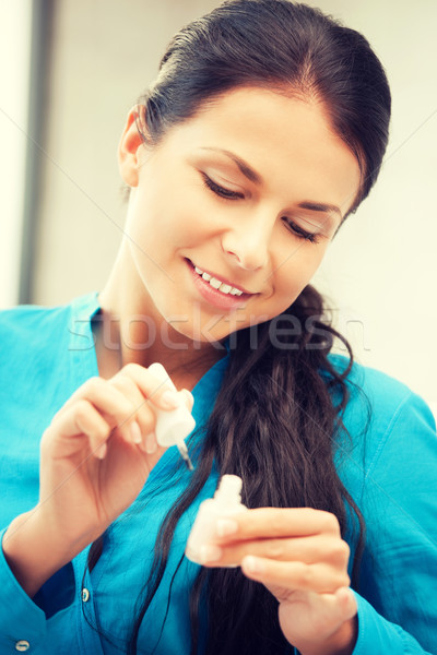 beautiful woman polishing her nails Stock photo © dolgachov