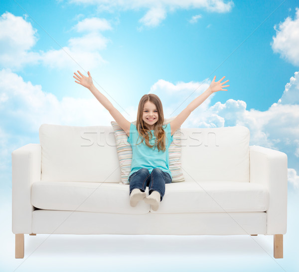 Menina feliz sessão sofá as mãos levantadas casa lazer Foto stock © dolgachov