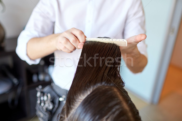male stylist hands combing wet hair at salon Stock photo © dolgachov