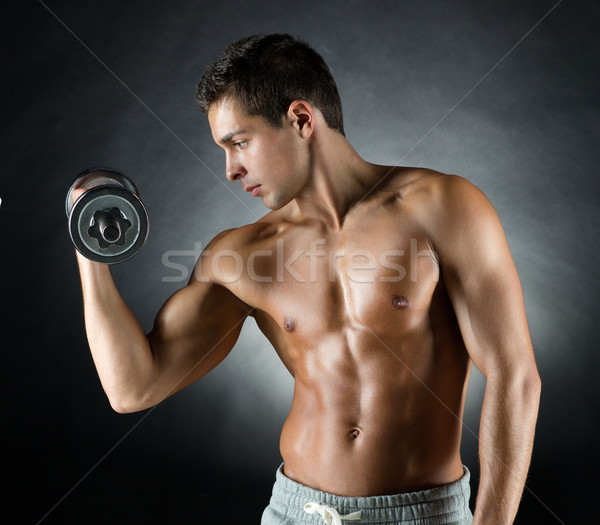 young man with dumbbell Stock photo © dolgachov