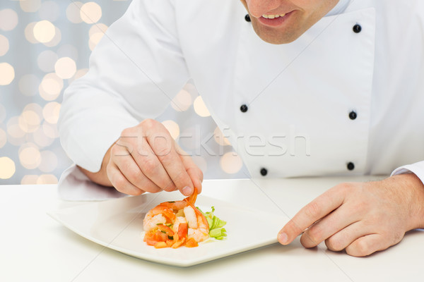 close up of happy male chef cook decorating dish Stock photo © dolgachov