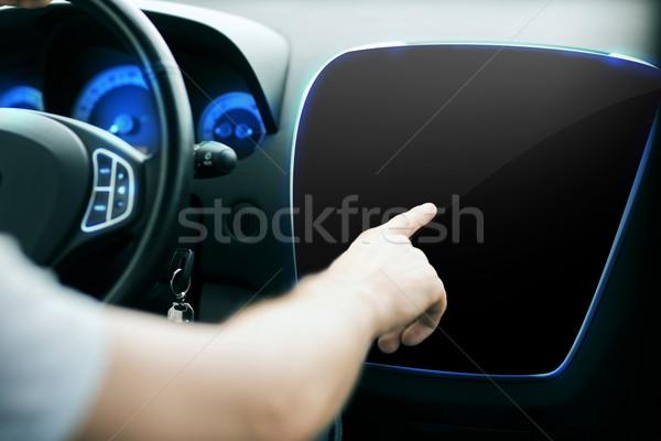 male hand pointing finger to monitor on car panel Stock photo © dolgachov