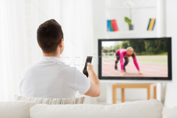 man watching sport channel on tv at home Stock photo © dolgachov